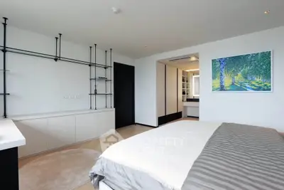 Spacious modern bedroom with minimalist decor and large window