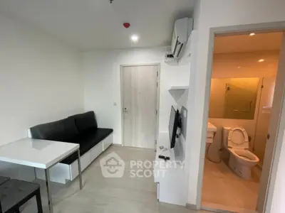 Modern compact living room with adjacent bathroom in minimalist apartment