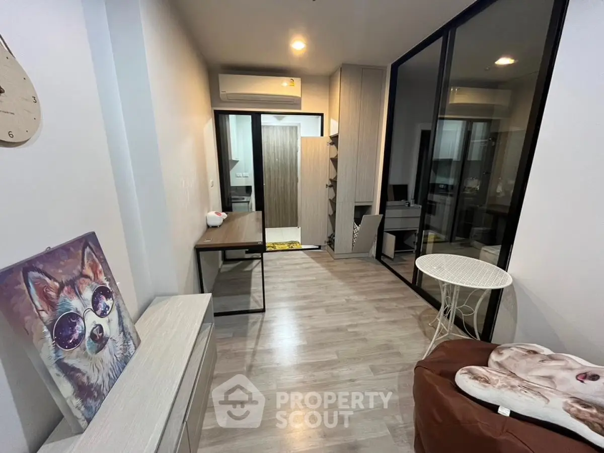 Modern interior with stylish decor and glass partition in a cozy living space.
