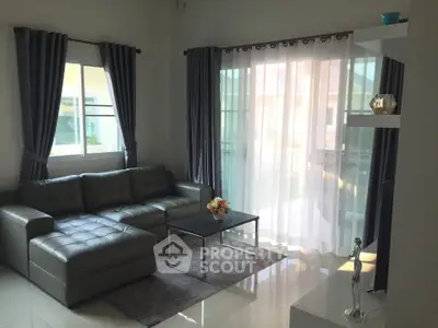 Modern living room with stylish gray sofa and elegant curtains