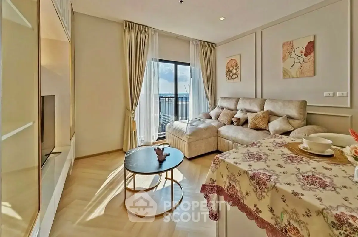 Spacious living room with elegant decor and large window offering stunning views.