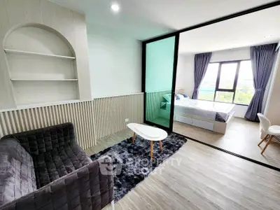 Modern studio apartment with stylish living area and cozy bedroom, featuring large windows and elegant decor.