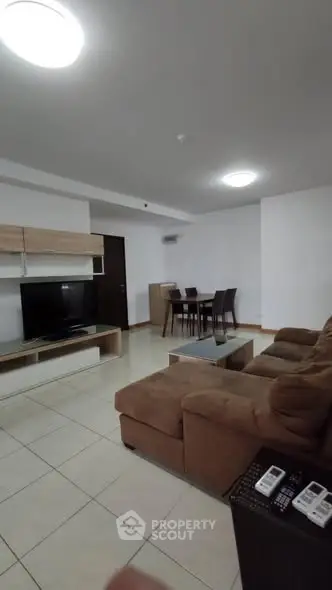 Spacious living room with modern furniture and dining area in open layout.