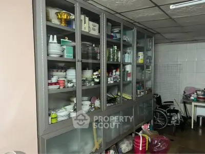 Spacious kitchen storage with glass cabinets and organized dishware