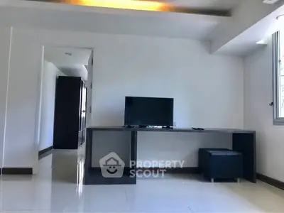 Modern living room with sleek TV stand and natural light