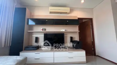 Modern living room with sleek entertainment center and air conditioning unit.