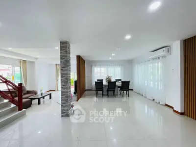 Spacious modern living and dining area with elegant decor and ample natural light.