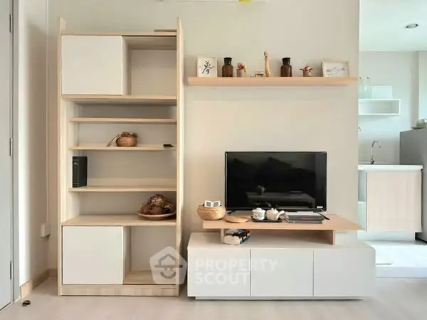 Modern living room with stylish shelving and TV unit, showcasing minimalist design and cozy ambiance.