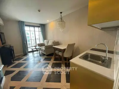 Stylish living room with modern decor and open kitchen layout in a cozy apartment.