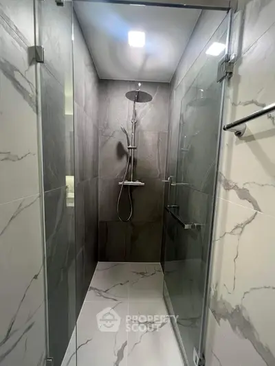 Modern bathroom with sleek glass shower and marble tiles