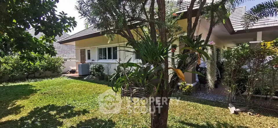 Charming suburban home with lush garden and modern roof design, perfect for family living.