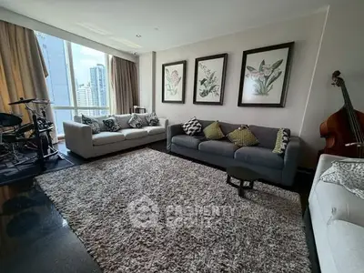 Spacious living room with modern decor and city view, featuring plush sofas and musical instruments.
