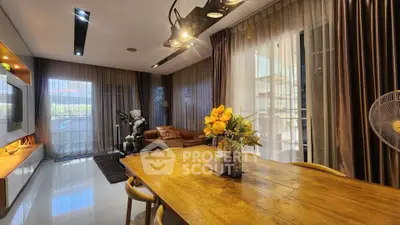 Spacious living room with elegant decor and natural light, featuring a cozy seating area and stylish dining table.
