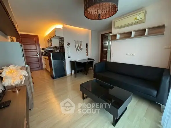 Modern living room with sleek furniture and open kitchen layout