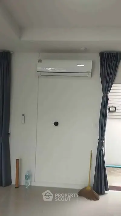 Modern interior with air conditioning and elegant curtains in a cozy living space.