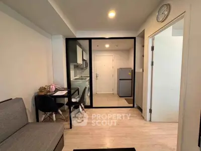 Modern apartment interior with open kitchen and dining area, featuring sleek design and contemporary furnishings.