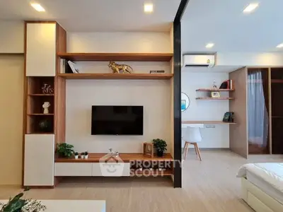 Modern living room with sleek wooden shelves and stylish decor in a contemporary apartment.