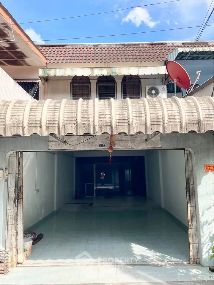 Charming townhouse with covered entrance and spacious interior, perfect for customization.