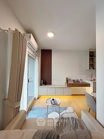 Stylish modern living room with natural light and cozy seating area.