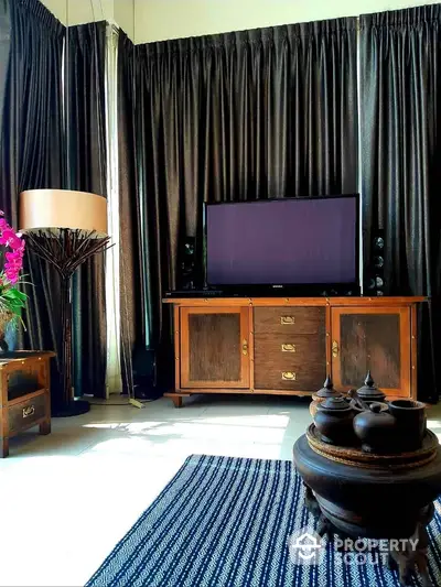 Elegant living room with vintage wooden furniture and modern TV setup