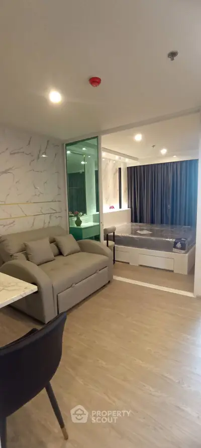 Luxurious modern living room with stylish sofa and elegant bathtub in open layout apartment.