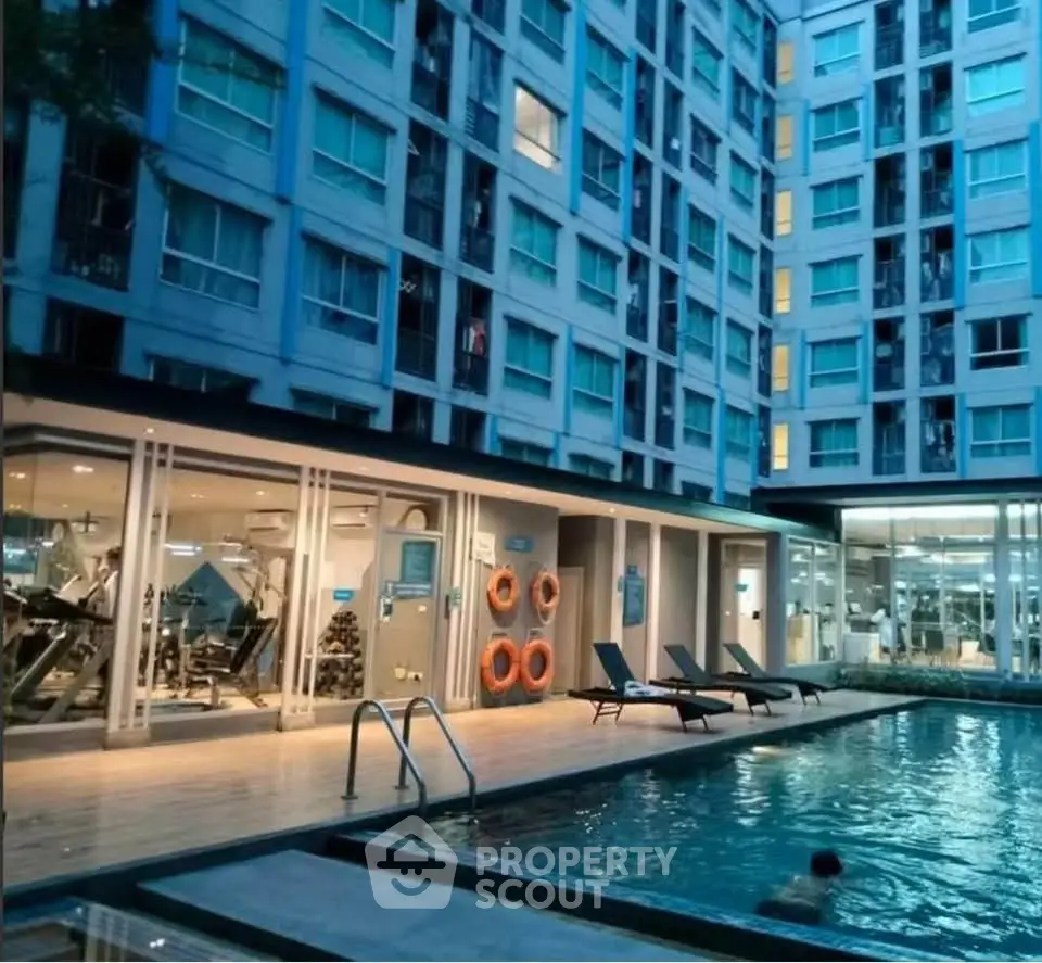Modern apartment complex with pool and gym facilities, ideal for urban living.