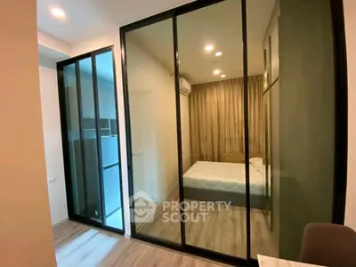 Modern bedroom with glass partition and cozy lighting in stylish apartment