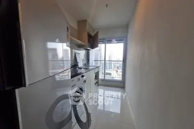 Modern kitchen with city view, featuring sleek appliances and glossy tiles.