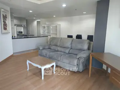 Spacious living room with modern kitchen and cozy sofa