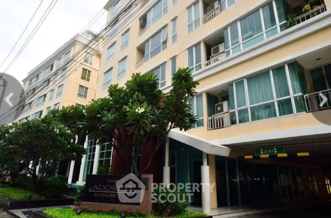 Modern condominium building exterior with lush greenery at The Address Sukhumvit 42.