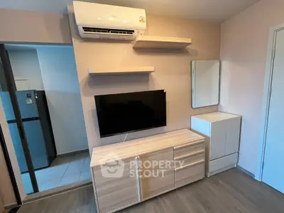 Modern living room with sleek TV setup and stylish air conditioning unit.