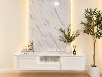 Elegant modern interior with marble accent wall and stylish decor