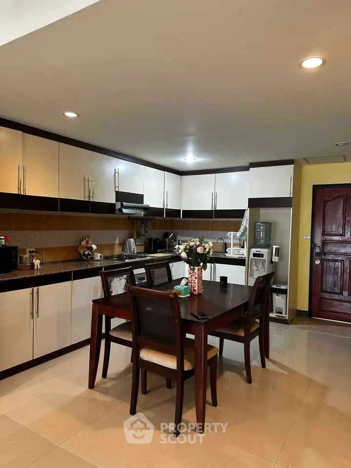 Spacious kitchen with dining area, modern cabinetry, and elegant decor in a cozy home setting.