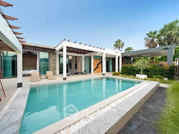 Luxurious modern villa with private pool and lush garden, perfect for relaxation and entertainment.