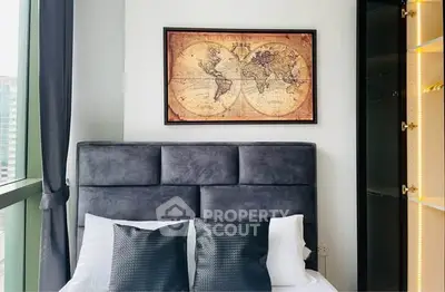 Modern bedroom with stylish decor and large window offering city views.