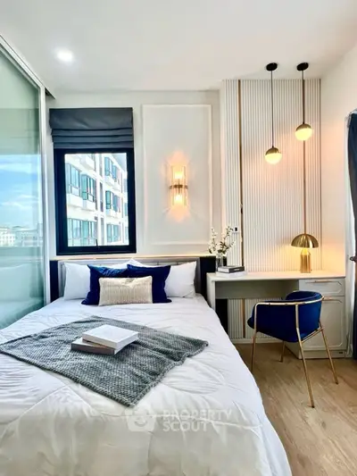 Modern bedroom with stylish decor, cozy bed, and elegant lighting in a bright apartment.