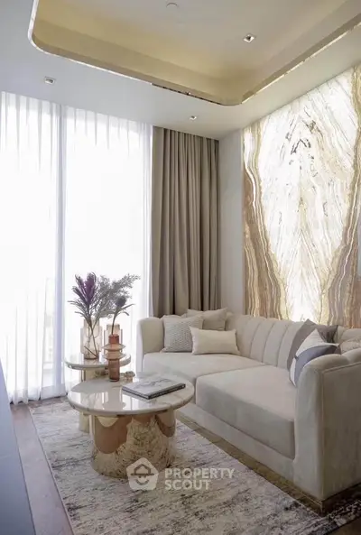 Luxurious living room with elegant marble accent wall and plush sofa, perfect for modern comfort and style.