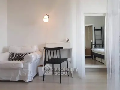 Cozy study area with white armchair and desk in modern apartment