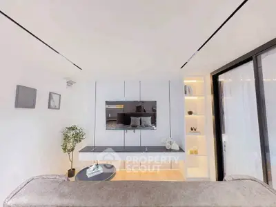 Modern living room with sleek design, featuring a wall-mounted TV, cozy sofa, and stylish shelving.