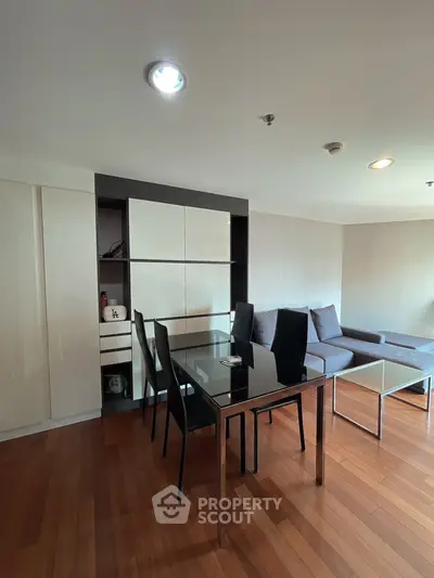 Modern living room with sleek furniture and wooden flooring, perfect for stylish urban living.