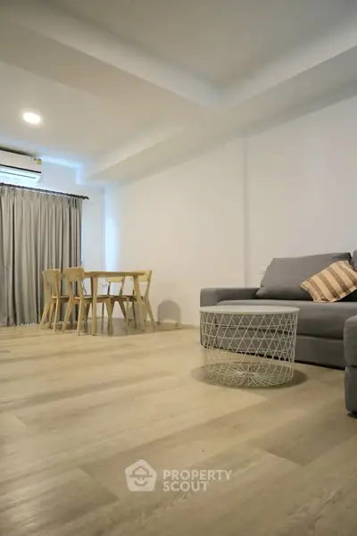 Spacious modern living room with stylish furniture and wooden flooring