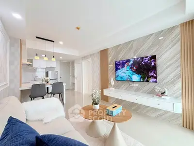 Modern living room with stylish decor, open kitchen layout, and wall-mounted TV for a contemporary lifestyle.