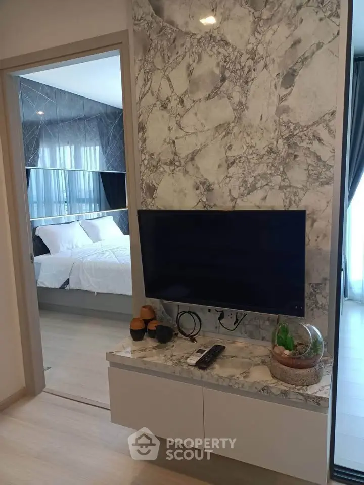 Modern bedroom with stylish marble TV wall and cozy decor