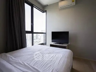 Modern bedroom with city view, featuring a large window, TV, and air conditioning.