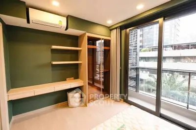Modern bedroom with large windows and built-in storage in urban apartment