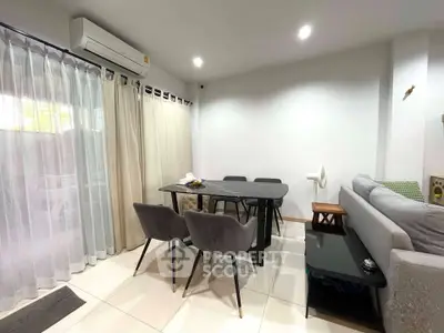 Modern living room with dining area and natural light
