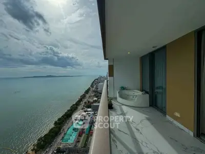 Stunning high-rise balcony with ocean view and luxurious outdoor bathtub.