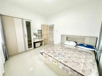 Spacious bedroom with modern furniture and ample natural light