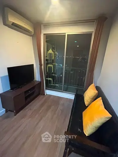 Cozy living room with balcony view, featuring modern furniture and ambient lighting.