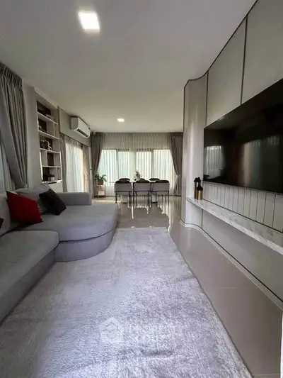 Spacious modern living room with elegant decor and large windows